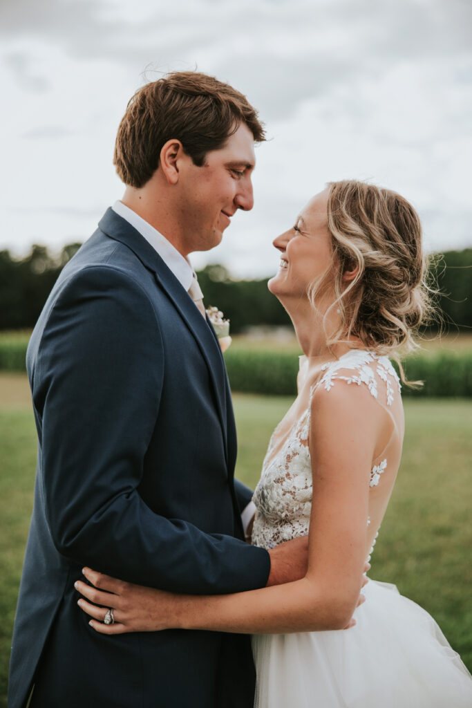 Groom looking lovingly at bride during sunset portrait session, Traverse City.