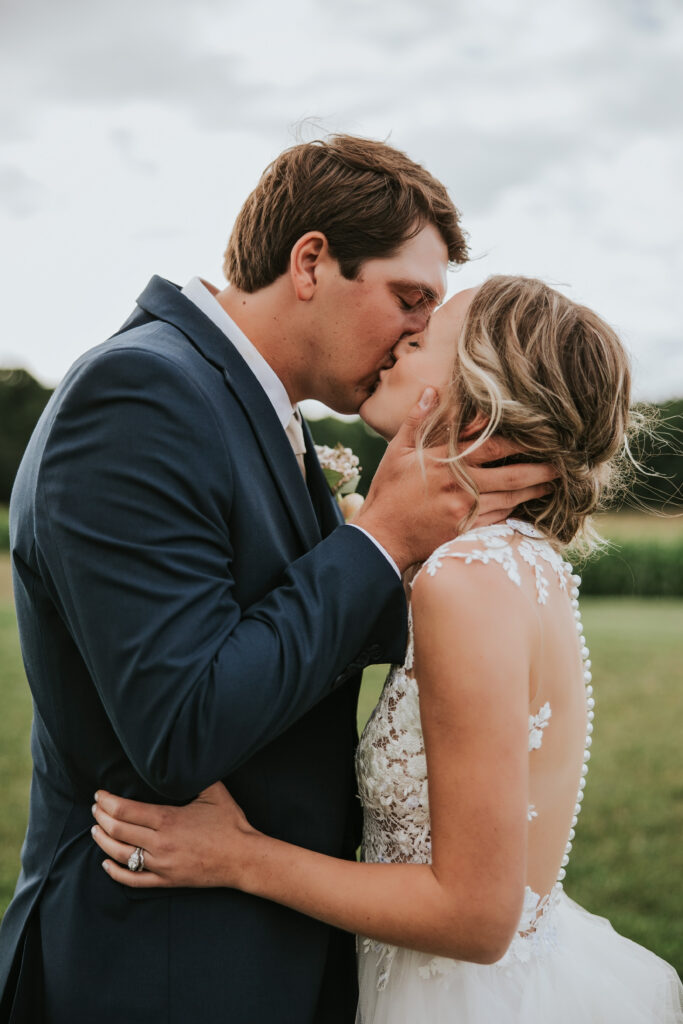 Bride and Groom sharing a kiss during golden hour at their Jacob's Farm Traverse City wedding