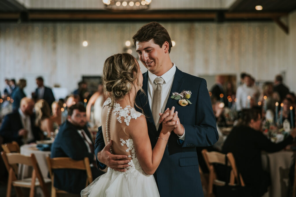 Bride and groom’s first dance in barn lit by candlelight, Traverse City.