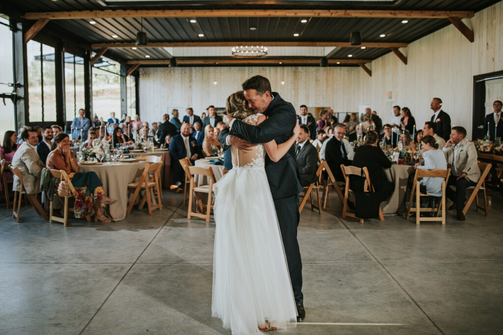 Bride's joyous dance with father in barn, Traverse City Wedding Photography.