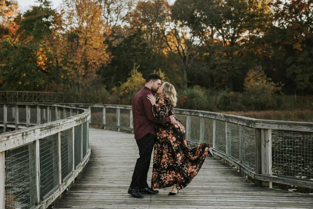 Bride and groom kissing on boardwalk at their Kensington Metropark Engagement Session