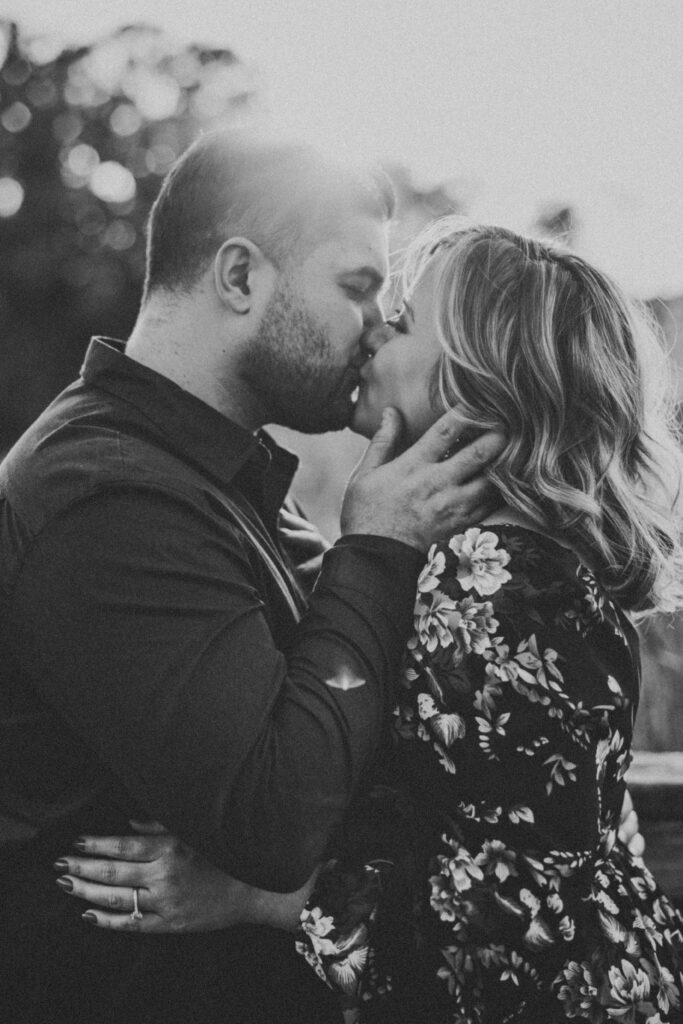 Black and white image of bride and groom kissing during their Kensington Metropark Engagement Session